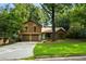 Charming home featuring mature trees, a two-car garage, and a well-maintained front lawn at 340 Windsor Se Walk, Conyers, GA 30094