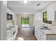 Well-lit kitchen featuring updated countertops, white cabinets, and stainless steel double sink at 340 Windsor Se Walk, Conyers, GA 30094