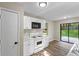 Bright kitchen featuring new white cabinets, vinyl floors, and sliding glass door to back yard at 340 Windsor Se Walk, Conyers, GA 30094