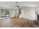 Open concept living room and staircase featuring vinyl plank floors and ample sunlight at 340 Windsor Se Walk, Conyers, GA 30094