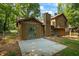 Rear exterior view of a house featuring sliding glass doors leading to a concrete patio at 340 Windsor Se Walk, Conyers, GA 30094