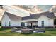 Large backyard patio with a stone fire pit and sitting area, ideal for gatherings and relaxation at 1290 Jack Page Ln, Canton, GA 30115