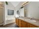 Bathroom with a soaking tub, walk-in shower, wood look flooring, and dual sinks at 1343 Cartwright Ln, Lawrenceville, GA 30045
