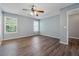This bedroom features new wood flooring and two windows allowing ample natural light at 1343 Cartwright Ln, Lawrenceville, GA 30045