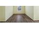 A bedroom with hardwood floors and a window for natural light at 1343 Cartwright Ln, Lawrenceville, GA 30045