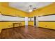 Bedroom featuring wood look flooring and yellow walls with black and white accents at 1343 Cartwright Ln, Lawrenceville, GA 30045