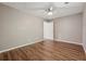 A neutrally painted bedroom with a fan and modern flooring at 1343 Cartwright Ln, Lawrenceville, GA 30045