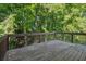 Large deck with wood railing overlooking mature trees at 1343 Cartwright Ln, Lawrenceville, GA 30045