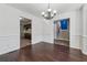 Dining room featuring dark hardwood floors, chandelier, and elegant trim at 1343 Cartwright Ln, Lawrenceville, GA 30045