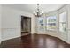 Dining room features dark wood floors, wainscoting, and bay window at 1343 Cartwright Ln, Lawrenceville, GA 30045