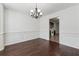Dining room featuring dark hardwood floors and chair rail with wainscoting at 1343 Cartwright Ln, Lawrenceville, GA 30045