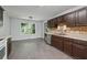 Kitchen features stainless steel appliances, tile floors, and adjacent dining area at 1343 Cartwright Ln, Lawrenceville, GA 30045