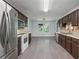 Kitchen features stainless steel appliances, tile floors, and adjacent dining area at 1343 Cartwright Ln, Lawrenceville, GA 30045