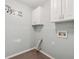 Laundry room with upper cabinets and hookups for a washer and dryer at 1343 Cartwright Ln, Lawrenceville, GA 30045