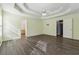 The large primary bedroom features a tray ceiling and a view of ensuite bathroom at 1343 Cartwright Ln, Lawrenceville, GA 30045
