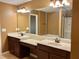 Bathroom vanity features dual sinks, modern lighting, and a neutral countertop at 1854 Caswell # 56, Marietta, GA 30060