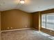 A cozy bedroom with neutral colored walls, carpet, and bright natural light from the windows at 1854 Caswell # 56, Marietta, GA 30060