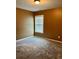 Cozy bedroom featuring neutral carpeting, a large window, and warm paint at 1854 Caswell # 56, Marietta, GA 30060