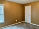 Carpeted bedroom features a window, a door, and neutral paint at 1854 Caswell # 56, Marietta, GA 30060