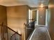 Hallway with wood railing, neutral walls, and carpet leading to doorways at 1854 Caswell # 56, Marietta, GA 30060
