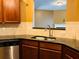 Kitchen with granite counters, stainless steel sink, and cherry wood cabinetry at 1854 Caswell # 56, Marietta, GA 30060