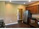 Kitchen featuring stainless steel appliances, granite countertops, and brown wooden cabinets at 1854 Caswell # 56, Marietta, GA 30060
