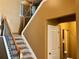 Carpeted stairs with wooden banister and metal spindles lead to the upper level at 1854 Caswell # 56, Marietta, GA 30060
