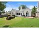 Well-maintained backyard with lush green grass, a brick patio, and a charming screened-in porch at 1805 Wilkenson Xing, Marietta, GA 30066