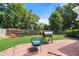 Backyard features a brick patio, a grill, and a lush lawn with mature trees offering shade and privacy at 1805 Wilkenson Xing, Marietta, GA 30066