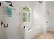 Bright bathroom with a glass shower and a soaking tub with a tile surround at 1805 Wilkenson Xing, Marietta, GA 30066