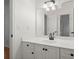 Bright bathroom with a white vanity, dark fixtures, and a large mirror reflecting a doorway at 1805 Wilkenson Xing, Marietta, GA 30066