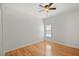 A bright bedroom featuring light hardwood floors, a ceiling fan, and a window with natural light at 1805 Wilkenson Xing, Marietta, GA 30066