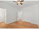 Bedroom features hardwood floors, a ceiling fan, and multiple closet doors for ample storage at 1805 Wilkenson Xing, Marietta, GA 30066