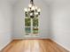 Dining room features hardwood floors, chandelier and views of the backyard at 1805 Wilkenson Xing, Marietta, GA 30066