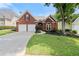 Beautiful brick home with a well-maintained lawn, mature trees, and a two-car garage at 1805 Wilkenson Xing, Marietta, GA 30066