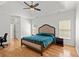 Bright main bedroom with hardwood floors, tray ceiling and a ceiling fan at 1805 Wilkenson Xing, Marietta, GA 30066