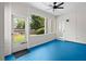 A sunroom featuring a ceiling fan, blue floor, a door and large windows providing ample natural light at 1805 Wilkenson Xing, Marietta, GA 30066