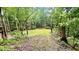 Large wooded backyard perfect for recreation or peaceful enjoyment with picnic table at 7460 Highway 101, Rockmart, GA 30153