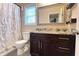Bathroom features a dark wood vanity with granite countertop, tiled shower, and a large mirror at 7460 Highway 101, Rockmart, GA 30153
