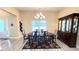 Dining room with a round table, six chairs, a china cabinet, and a modern chandelier at 7460 Highway 101, Rockmart, GA 30153