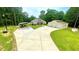 View of home featuring a carport and detached garage surrounded by green lawns and trees at 7460 Highway 101, Rockmart, GA 30153