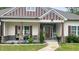 Inviting front porch with stone accents, rocking chair, and stylish decor, creating a cozy outdoor space at 7460 Highway 101, Rockmart, GA 30153