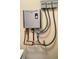 Close-up of a modern, energy-efficient tankless water heater with copper piping at 7460 Highway 101, Rockmart, GA 30153