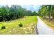 Driveway leading up to property; showcasing the expansive land and trees at 7460 Highway 101, Rockmart, GA 30153