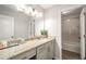 Bathroom with modern lighting and finishes, including a granite counter and framed mirror at 1024 Brownstone Dr # 2, Marietta, GA 30008