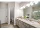 Bathroom with gray dual vanity, granite countertop, large mirror and tile floors at 1024 Brownstone Dr # 2, Marietta, GA 30008