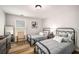 Charming bedroom featuring two twin beds, neutral walls, wood floors, and plenty of natural light from the window at 1024 Brownstone Dr # 2, Marietta, GA 30008