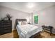 Comfortable bedroom with a queen size bed, a nightstand and a dark wood dresser at 1024 Brownstone Dr # 2, Marietta, GA 30008