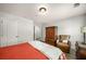 Relaxing bedroom with red comforter, wood floors, natural light and a comfortable armchair and antique furnishings at 1024 Brownstone Dr # 2, Marietta, GA 30008