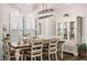 Bright dining room features modern lighting, shutters, wood floors and adjacent to storage cabinet at 1024 Brownstone Dr # 2, Marietta, GA 30008